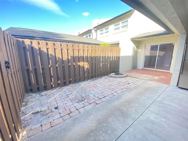 a view of empty room with wooden floor and fence