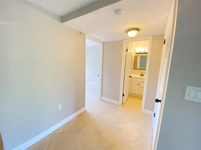 a view of a hallway with wooden shelves