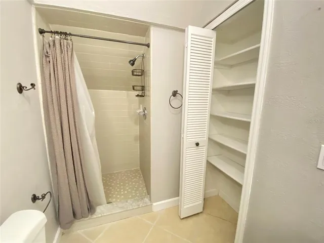a bathroom with a shower and a glass door