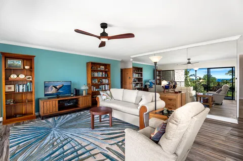 a living room with furniture and a wooden floor