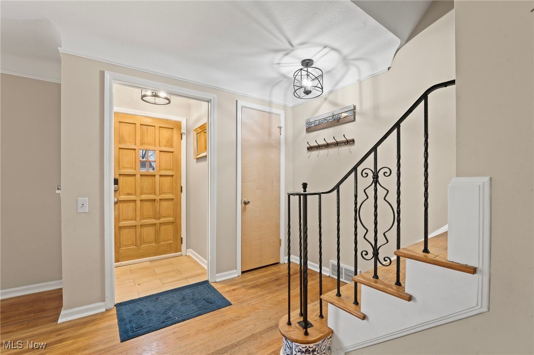 5232 East Farnhurst Road Cleveland, OH 44124 - Photo 4 of 28 Foyer entrance featuring light wood-type flooring and a chandelier