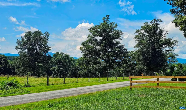 a view of a park with houses in the background