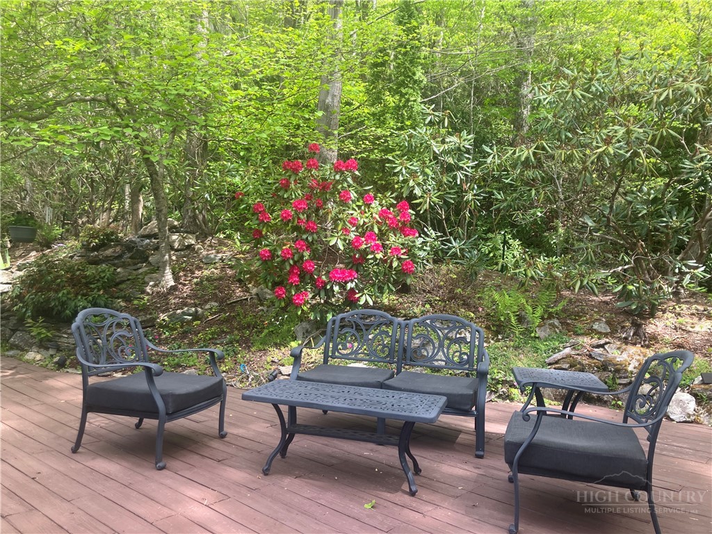 220 Woodwinds Lane Seven Devils, NC 28604 - Photo 9 of 48 a outdoor living space with furniture and flowers