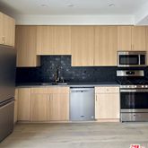 a kitchen with stainless steel appliances a stove a sink and a microwave