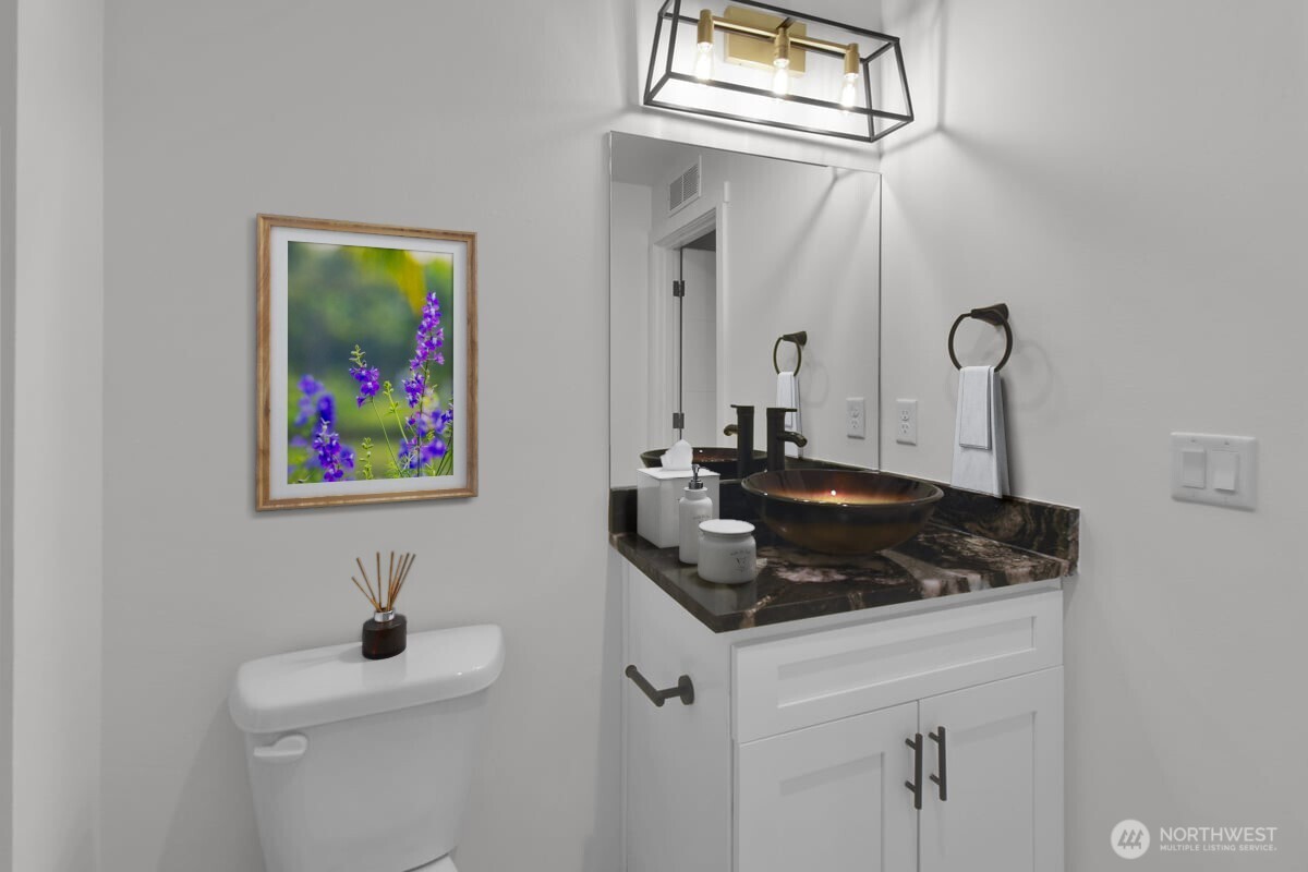 3117 Northeast 133rd Street, Unit D Seattle, WA 98125 - Photo 16 of 22 a bathroom with a sink and a mirror