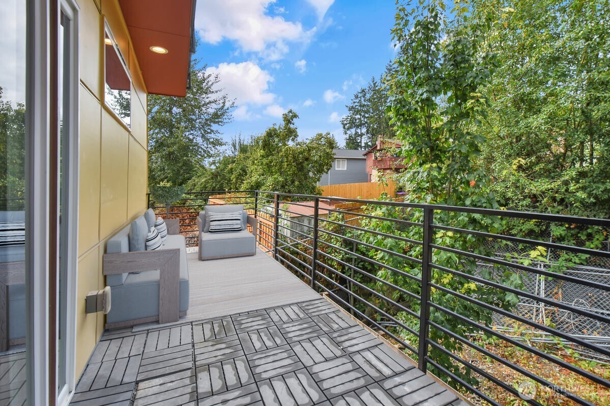 3117 Northeast 133rd Street, Unit D Seattle, WA 98125 - Photo 17 of 22 a view of a balcony with wooden floor
