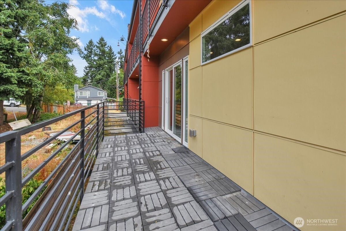3117 Northeast 133rd Street, Unit D Seattle, WA 98125 - Photo 20 of 22 a view of a balcony with wooden floor