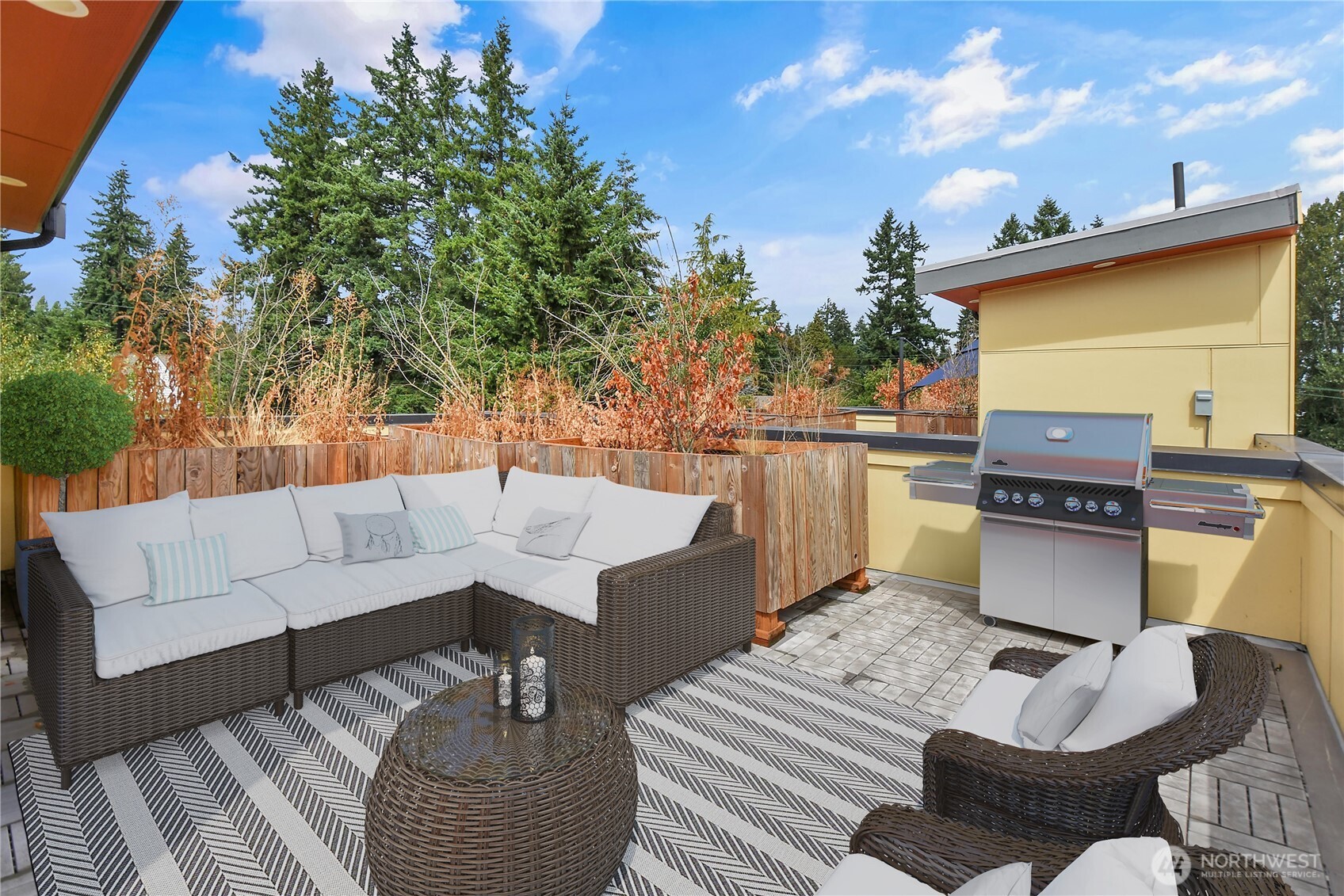 3117 Northeast 133rd Street, Unit D Seattle, WA 98125 - Photo 21 of 22 a roof deck with couches and potted plants