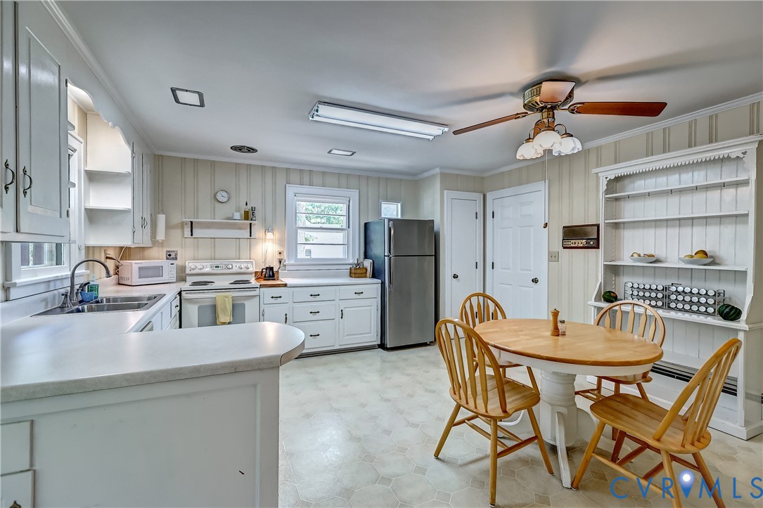 1817 Pocoshock Boulevard North Chesterfield, VA 23235 - Photo 17 of 41 a kitchen with stainless steel appliances kitchen island granite countertop a dining table chairs and refrigerator