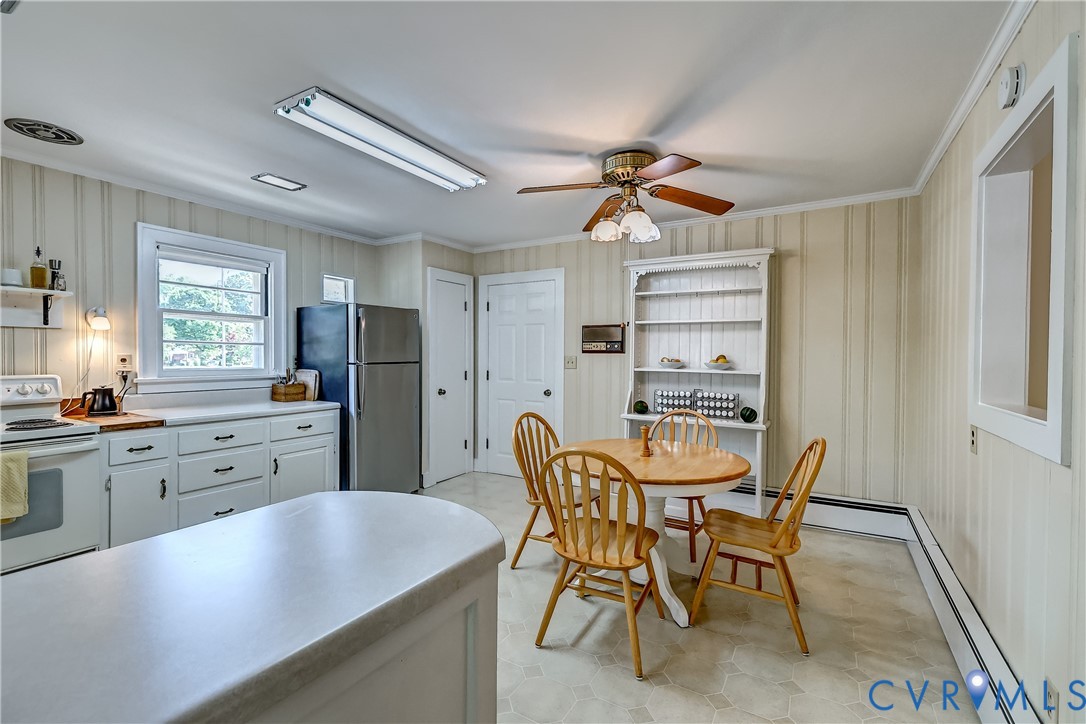 1817 Pocoshock Boulevard North Chesterfield, VA 23235 - Photo 18 of 41 a kitchen with stainless steel appliances kitchen island granite countertop furniture and a refrigerator