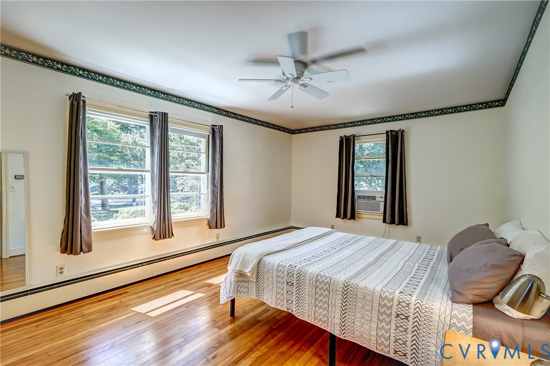 1817 Pocoshock Boulevard North Chesterfield, VA 23235 - Photo 22 of 41 a bedroom with a bed and wooden floor