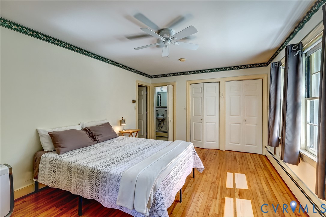 1817 Pocoshock Boulevard North Chesterfield, VA 23235 - Photo 23 of 41 a bedroom with a large bed and a chandelier