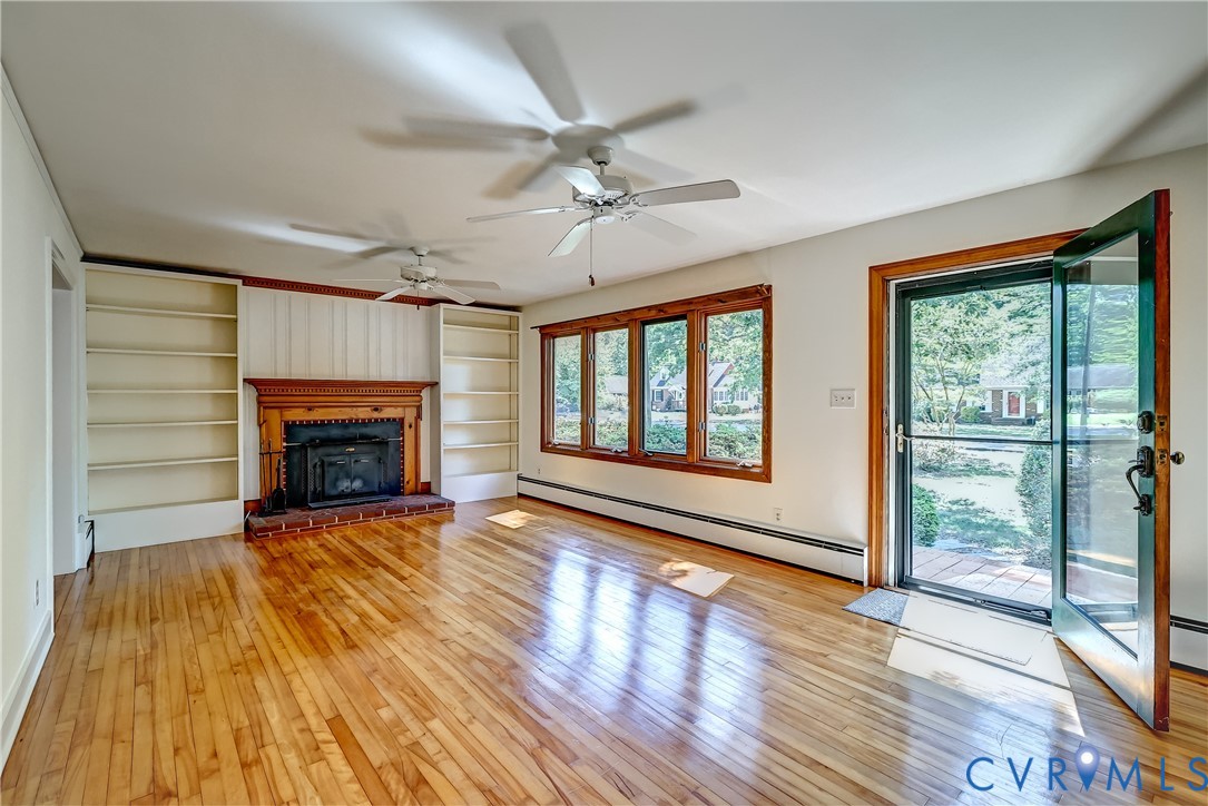 1817 Pocoshock Boulevard North Chesterfield, VA 23235 - Photo 8 of 41 wooden floor fireplace and windows in an empty room