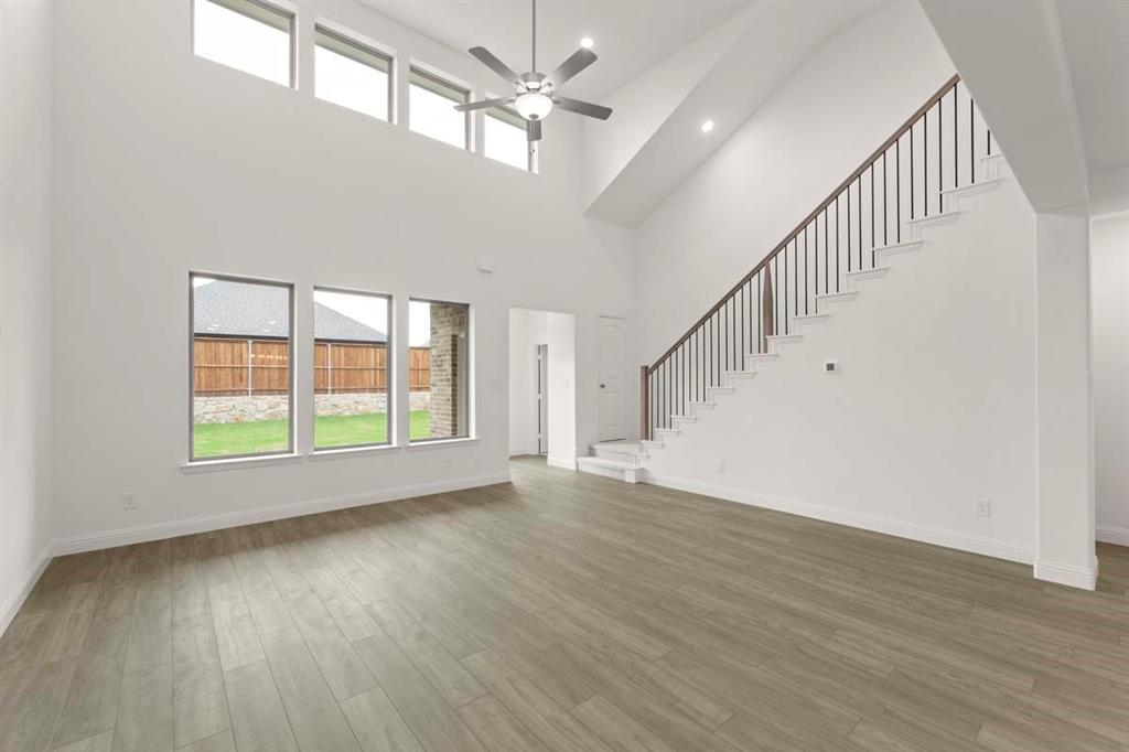1443 Canadian Lane Van Alstyne, TX 75495 - Photo 8 of 24 08-1443-canadian-ln-van-alstyne-tx-living-room-staircase