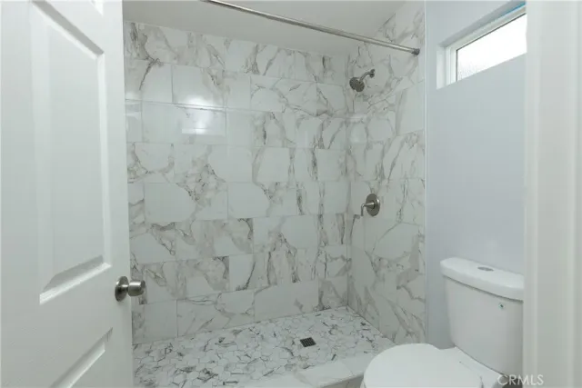 a bathroom with a toilet and shower