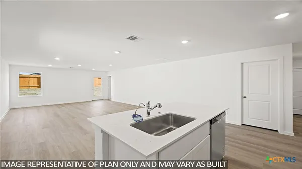 a view of kitchen with cabinets and wooden floor