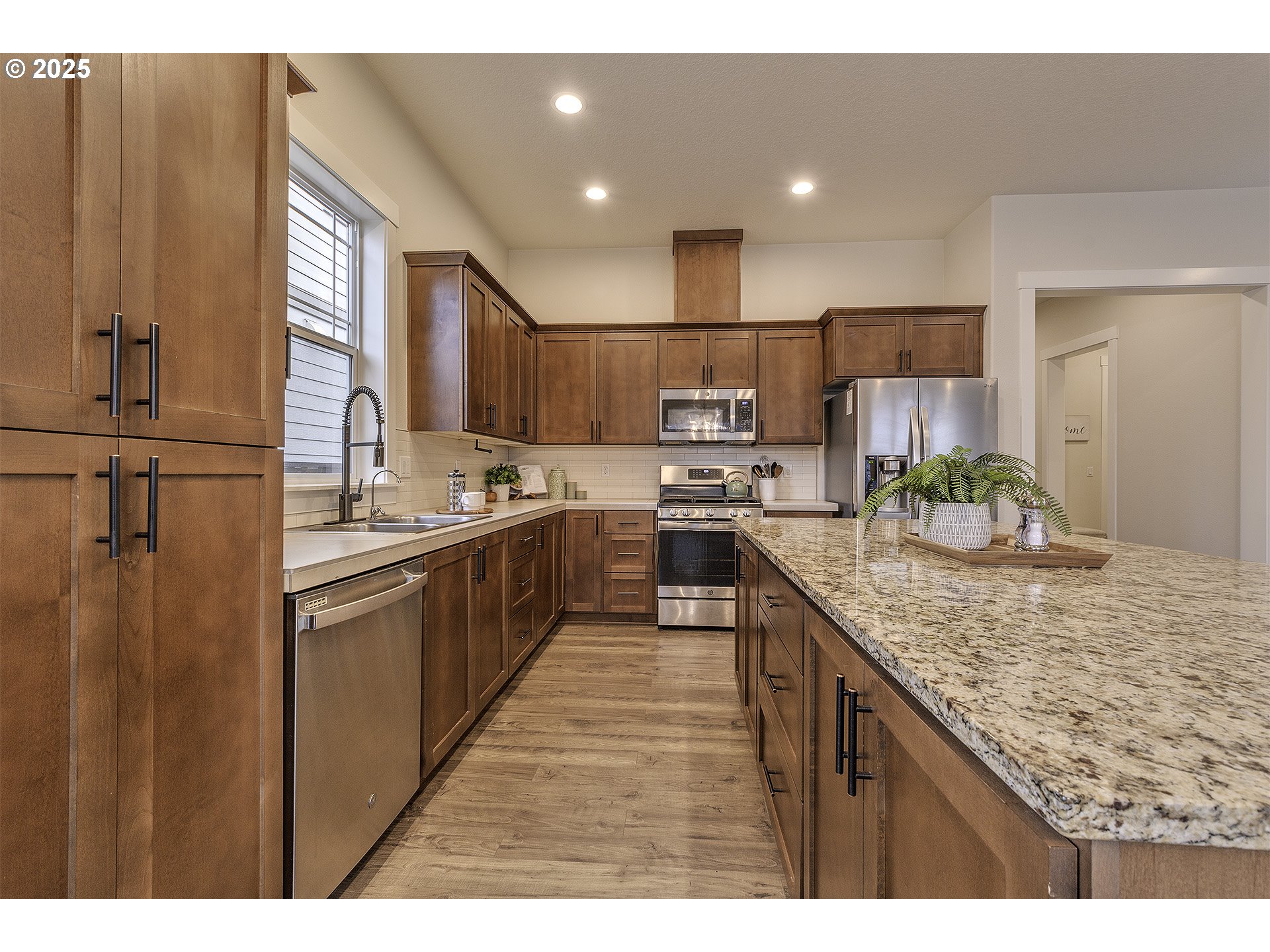 29068 Northwest Fair Street North Plains, OR 97133 - Photo 11 of 29 a kitchen with kitchen island granite countertop a sink appliances cabinets and counter space