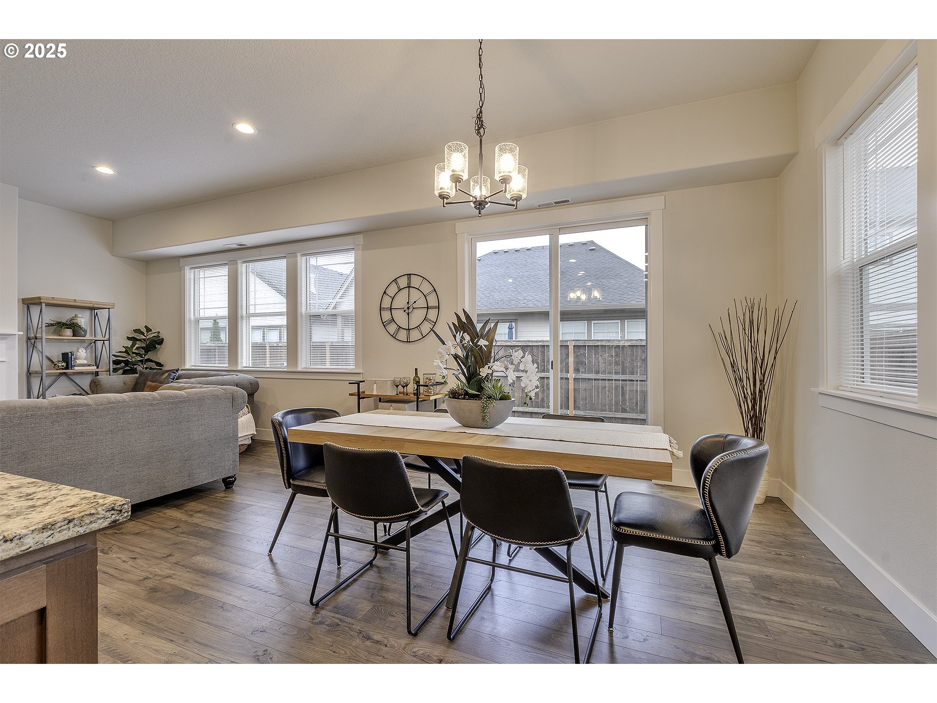 29068 Northwest Fair Street North Plains, OR 97133 - Photo 12 of 29 a view of a dining room with furniture a chandelier and wooden floor