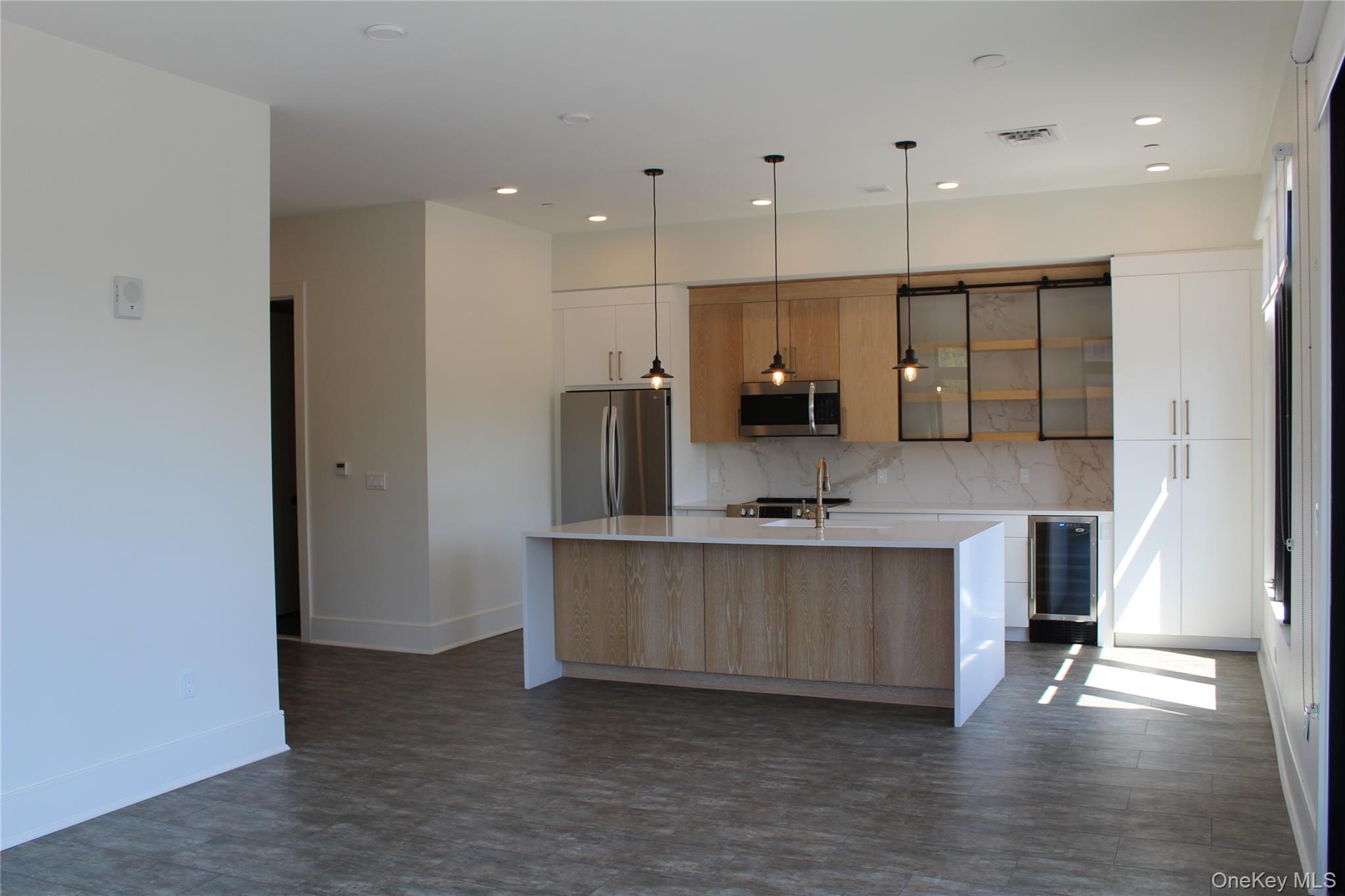 331 East Main Street Riverhead, NY 11901 - Photo 2 of 7 a large kitchen with stainless steel appliances a large counter top a stove and a refrigerator