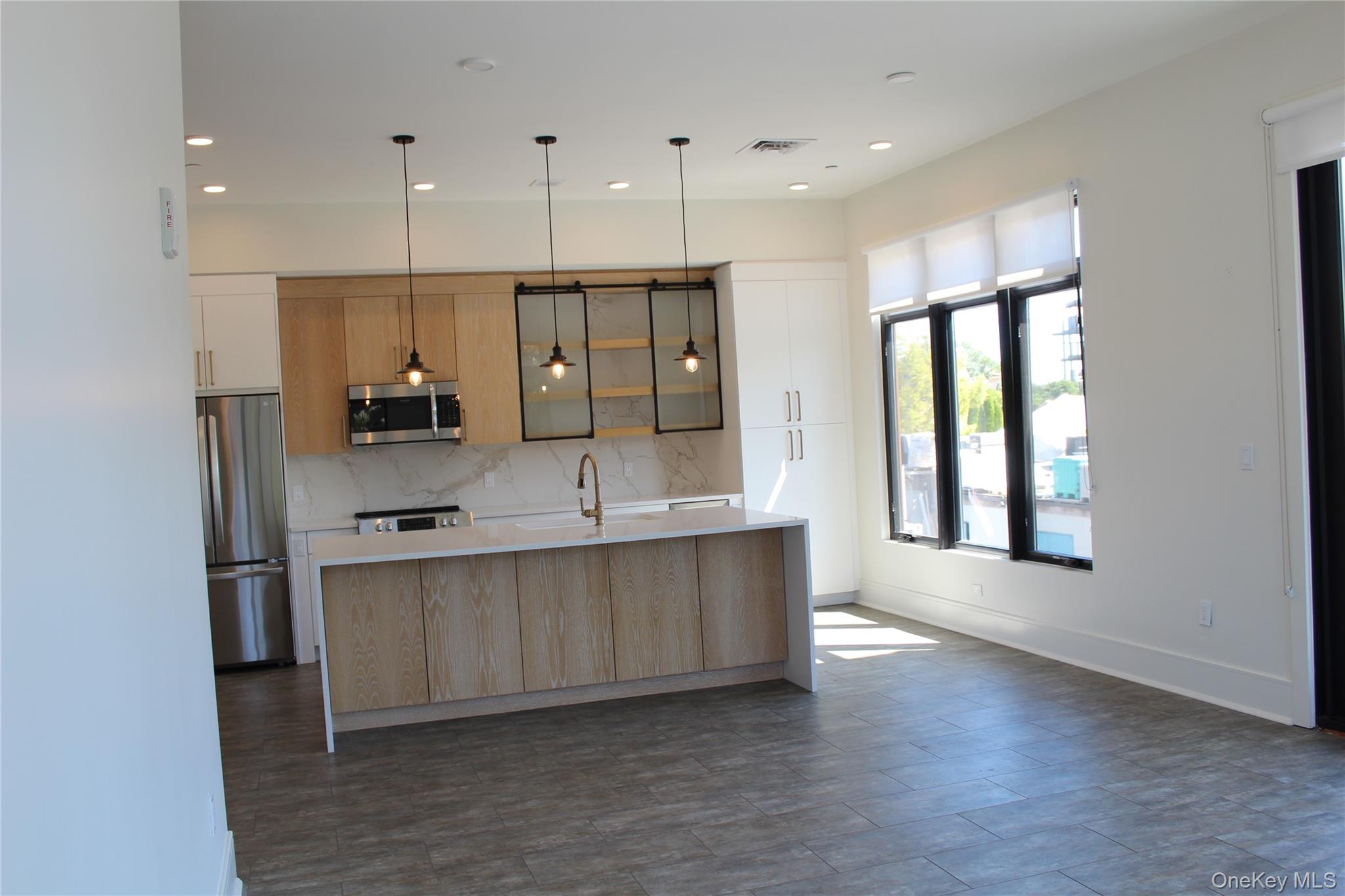 331 East Main Street Riverhead, NY 11901 - Photo 3 of 7 a large kitchen with a large window and stainless steel appliances