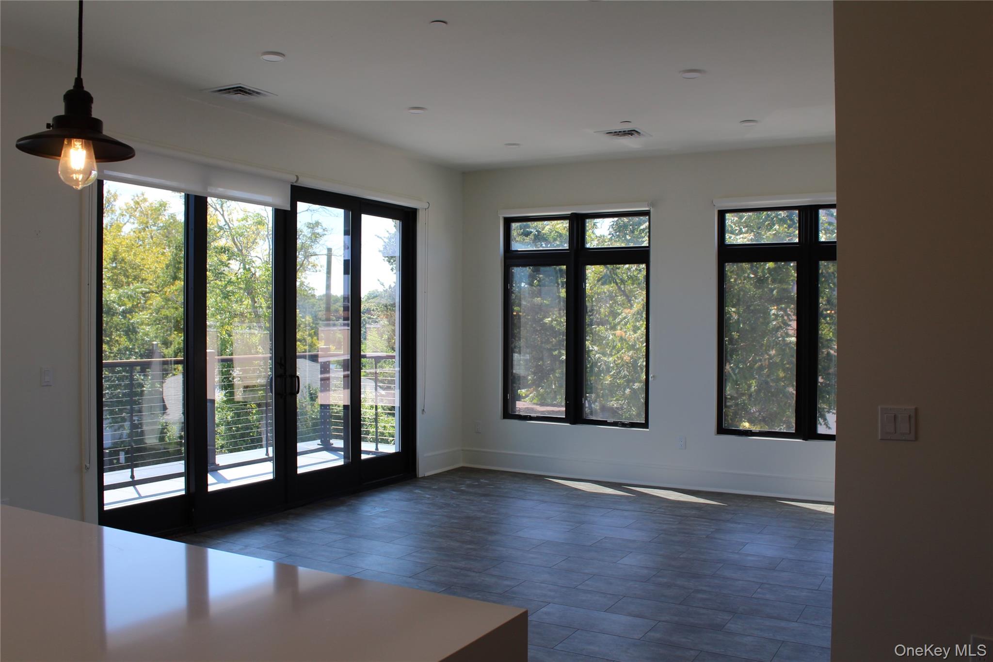 331 East Main Street Riverhead, NY 11901 - Photo 4 of 7 a view of an empty room with wooden floor and windows