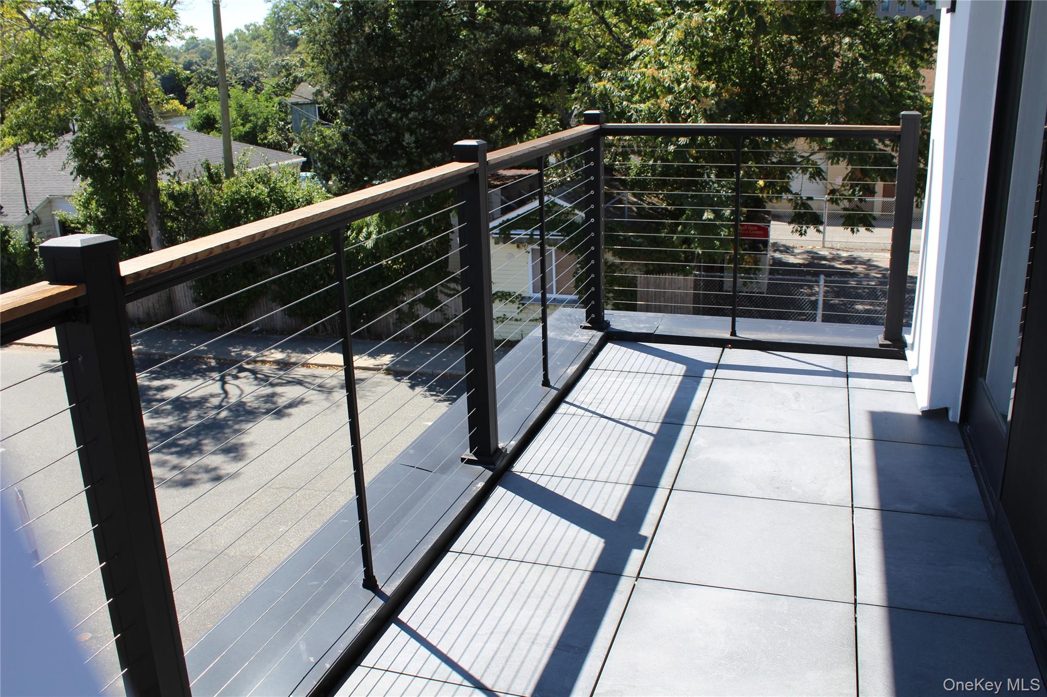 331 East Main Street Riverhead, NY 11901 - Photo 5 of 7 a view of balcony with wooden floor and windows