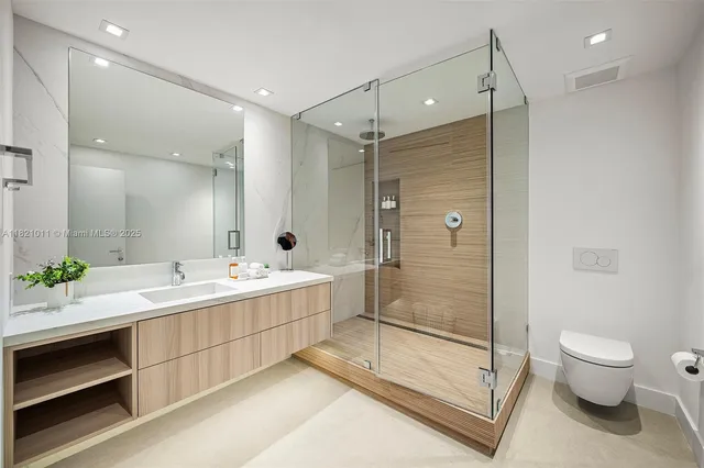 a bathroom with a double vanity sink toilet and shower