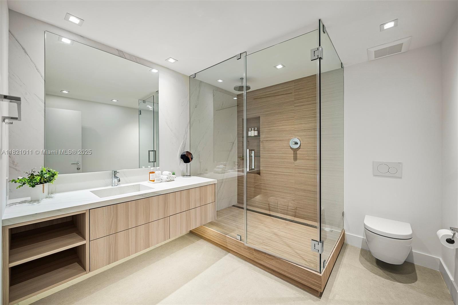 2301 Collins Avenue, Unit 630 Miami Beach, FL 33139 - Photo 11 of 48 a bathroom with a double vanity sink toilet and shower