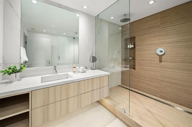 a bathroom with a double vanity sink mirror and shower