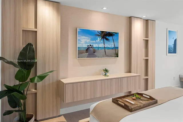 a bedroom with a bed and a painting on the wall