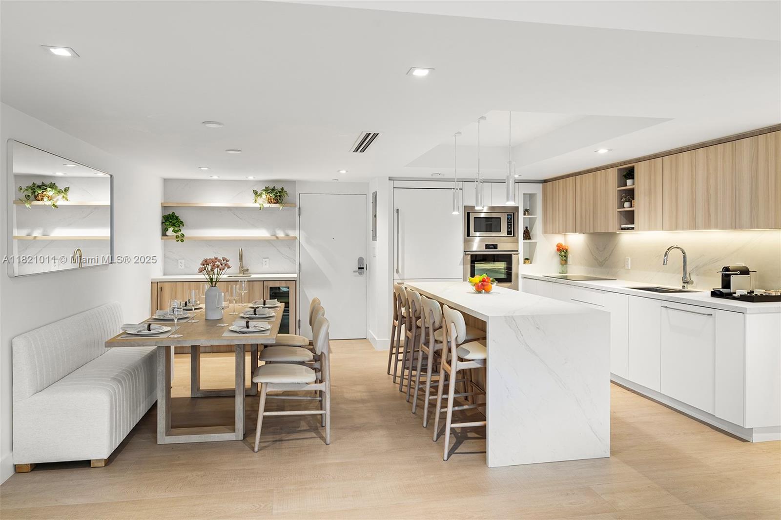 2301 Collins Avenue, Unit 630 Miami Beach, FL 33139 - Photo 2 of 48 a kitchen with a table chairs microwave and cabinets
