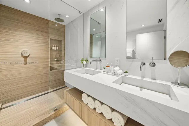 a bathroom with double vanity sink and a mirror
