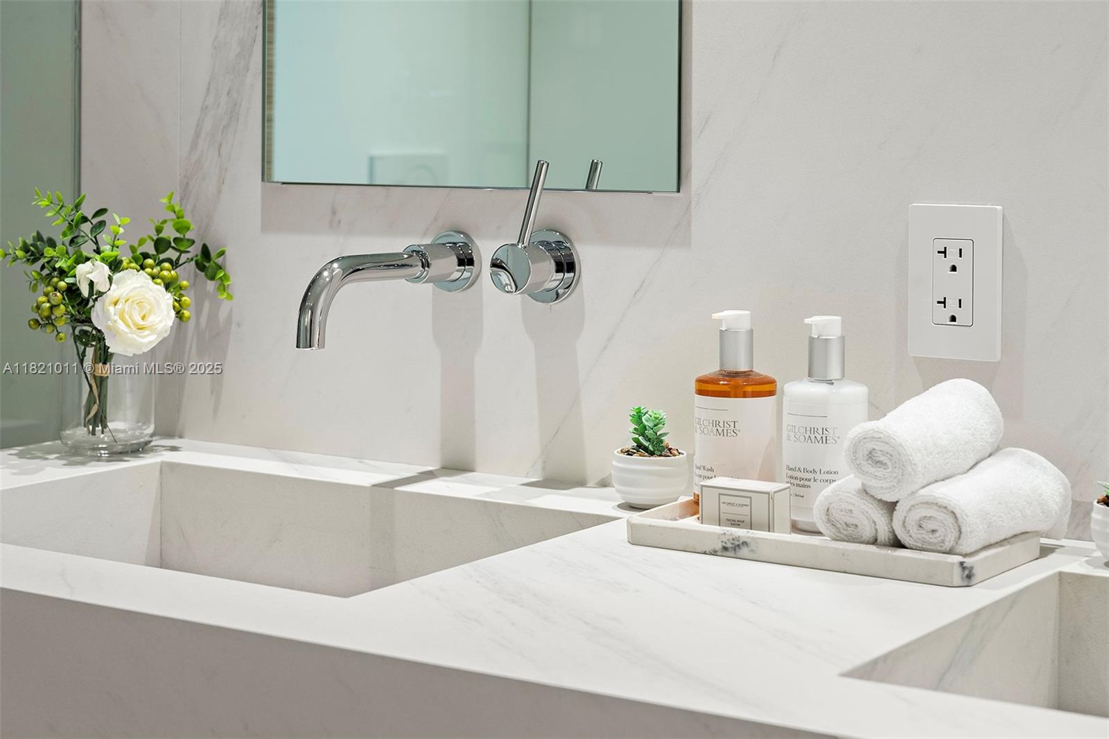 2301 Collins Avenue, Unit 630 Miami Beach, FL 33139 - Photo 23 of 48 a bathroom with a sink and a mirror