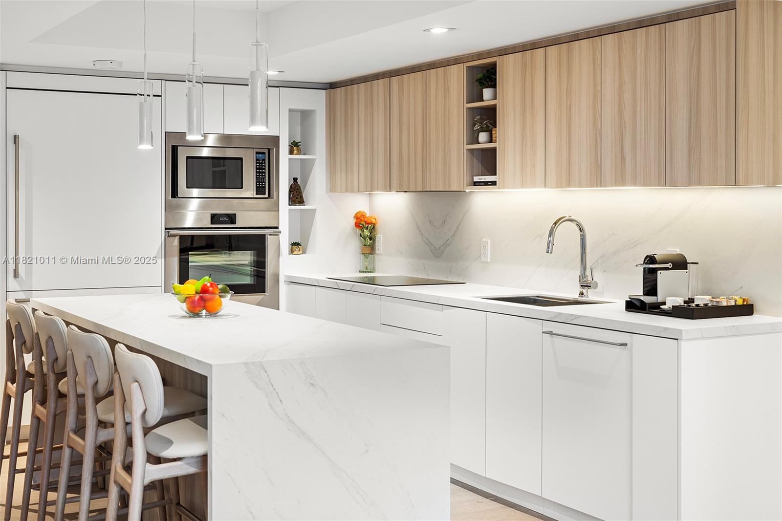 2301 Collins Avenue, Unit 630 Miami Beach, FL 33139 - Photo 30 of 48 a kitchen with stainless steel appliances a microwave a sink and cabinets