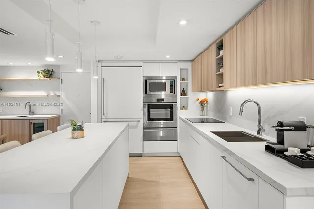 a kitchen that has a lot of cabinets in it and appliances