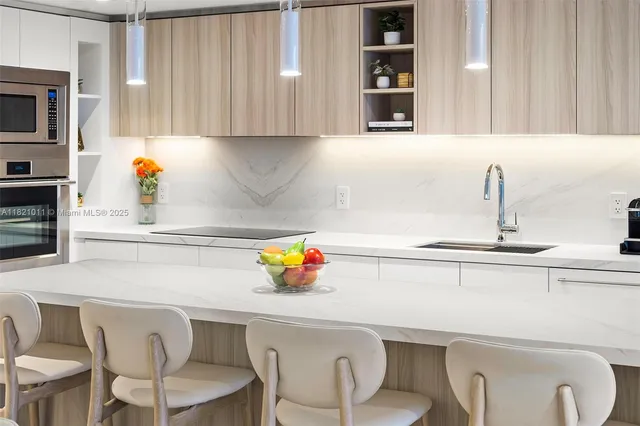 a kitchen with a sink cabinets and appliances