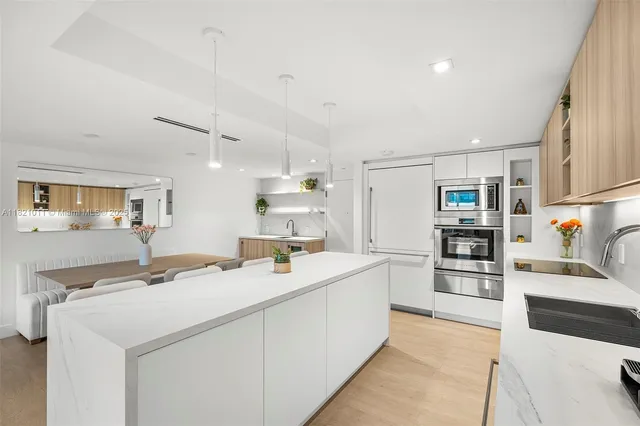 a kitchen with a sink appliances and cabinets