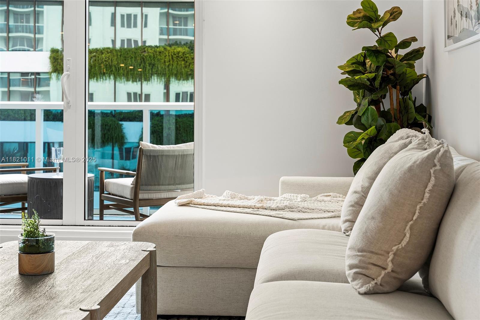 2301 Collins Avenue, Unit 630 Miami Beach, FL 33139 - Photo 39 of 48 a living room with furniture flowerpot and wooden floor
