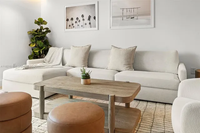 a living room with furniture and flowers