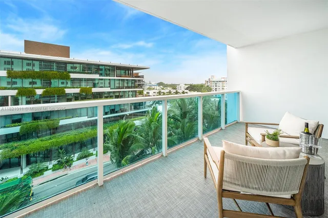 a view of a chairs and table in a balcony