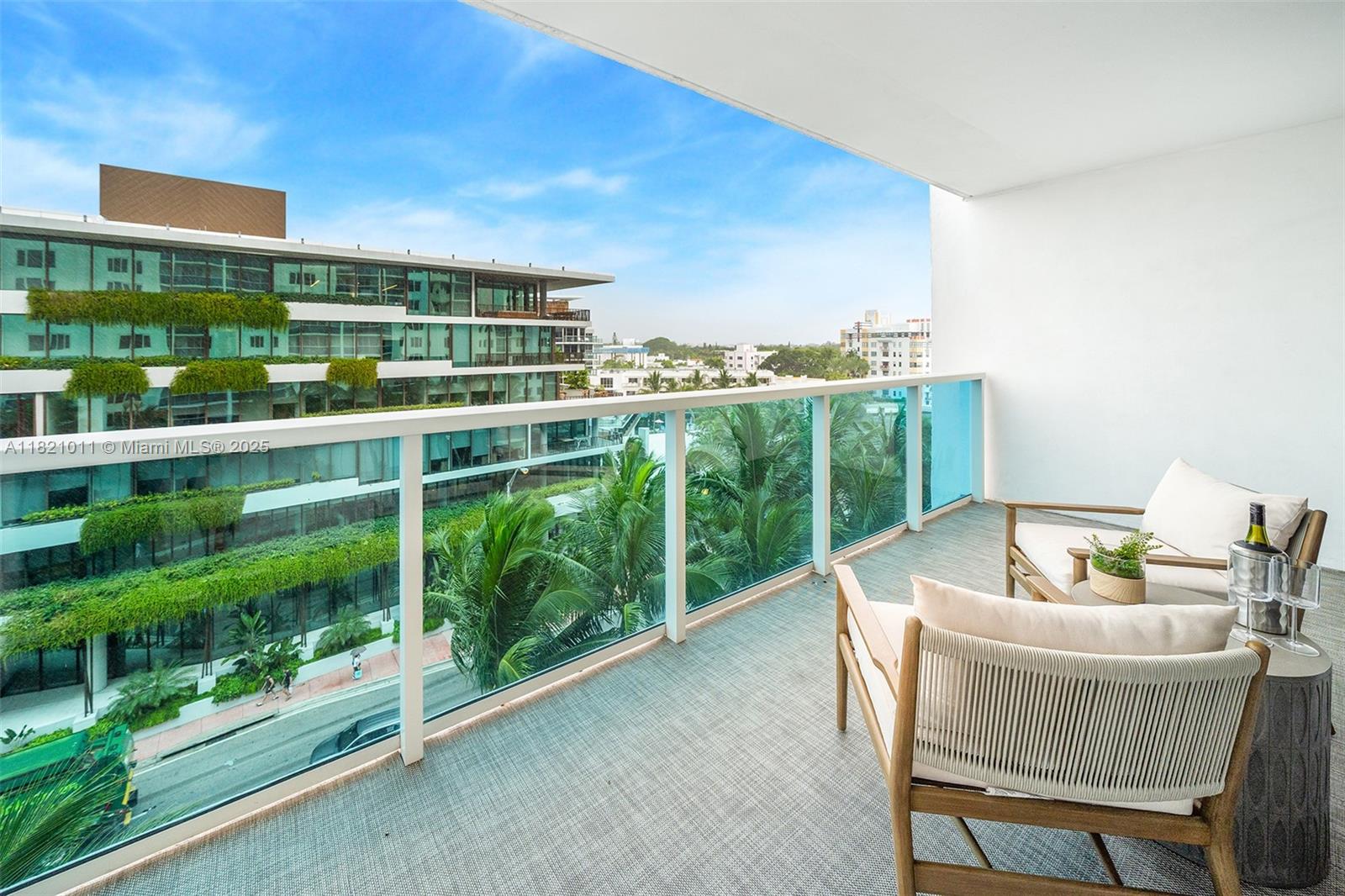 2301 Collins Avenue, Unit 630 Miami Beach, FL 33139 - Photo 45 of 48 a view of a chairs and table in a balcony