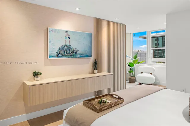 a bedroom with a bed and a painting on the wall