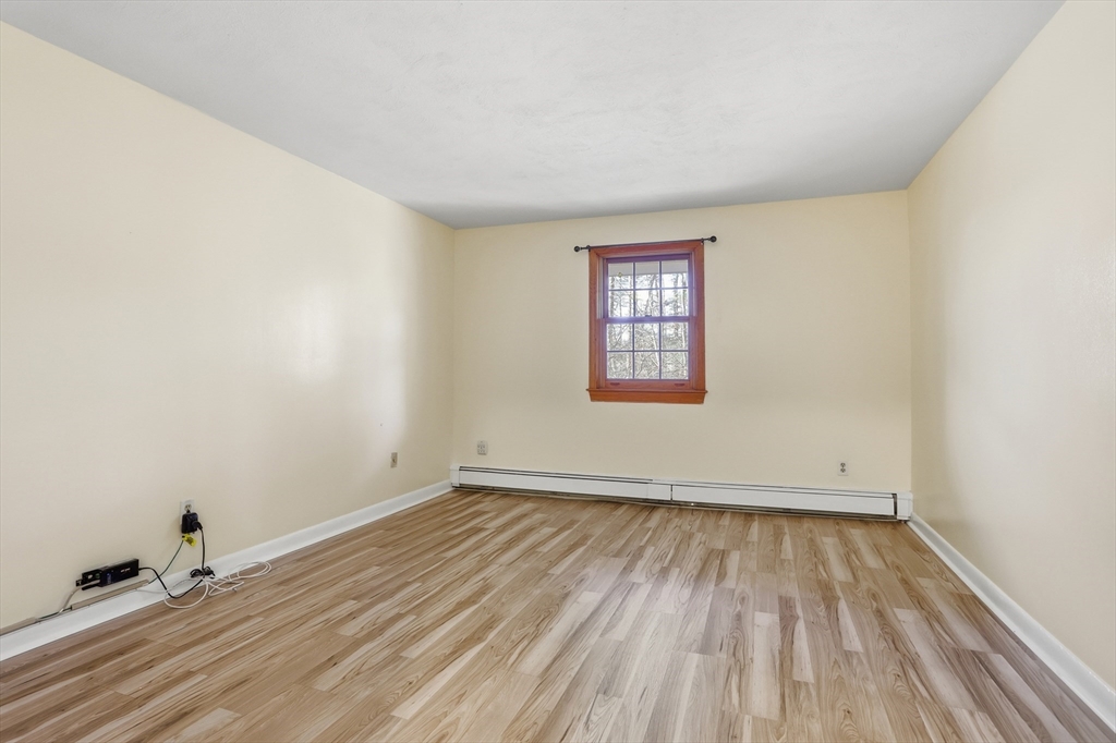 209 Great Road, Unit C3 Acton, MA 01720 - Photo 11 of 24 an empty room with wooden floor and windows