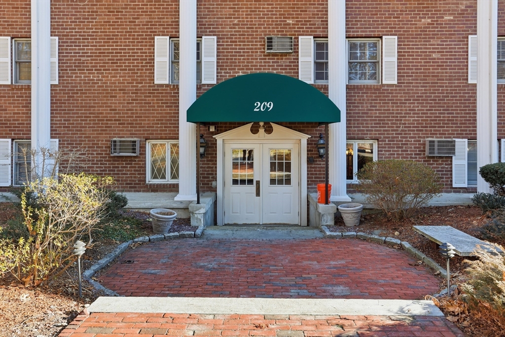 209 Great Road, Unit C3 Acton, MA 01720 - Photo 20 of 24 a front view of a house with garden