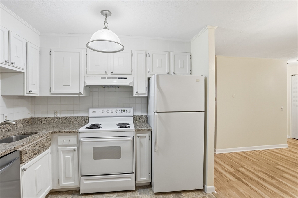 209 Great Road, Unit C3 Acton, MA 01720 - Photo 2 of 24 a kitchen with appliances a refrigerator a sink and cabinets