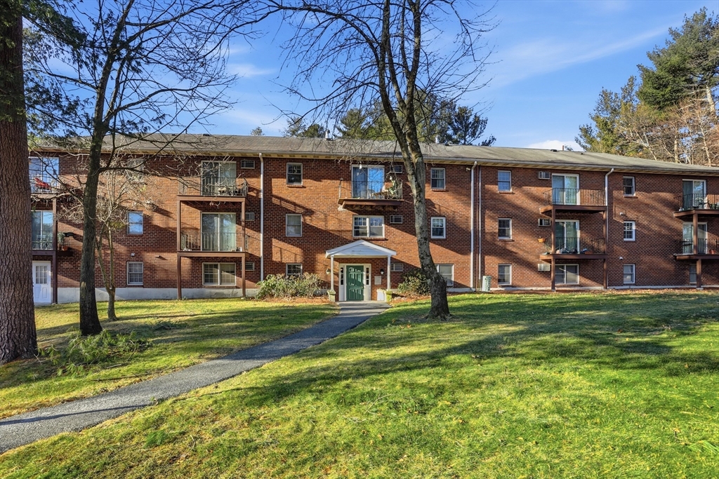 209 Great Road, Unit C3 Acton, MA 01720 - Photo 21 of 24 a front view of a house with a yard
