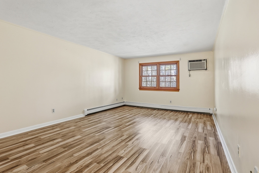 209 Great Road, Unit C3 Acton, MA 01720 - Photo 5 of 24 an empty room with wooden floor and windows