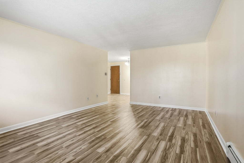 209 Great Road, Unit C3 Acton, MA 01720 - Photo 6 of 24 a view of an empty room with wooden floor