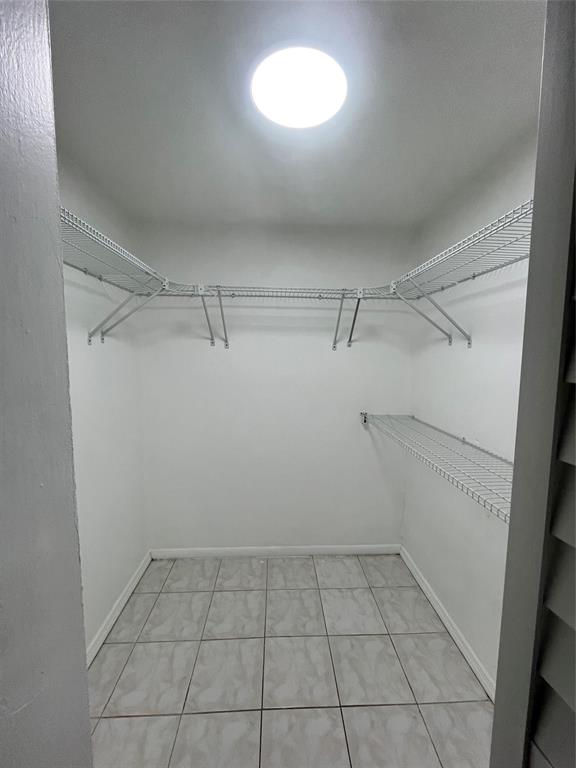 7925 Fairview Drive, Unit 101 Tamarac, FL 33321 - Photo 17 of 48 a view of a room with an empty space and racks on the wall