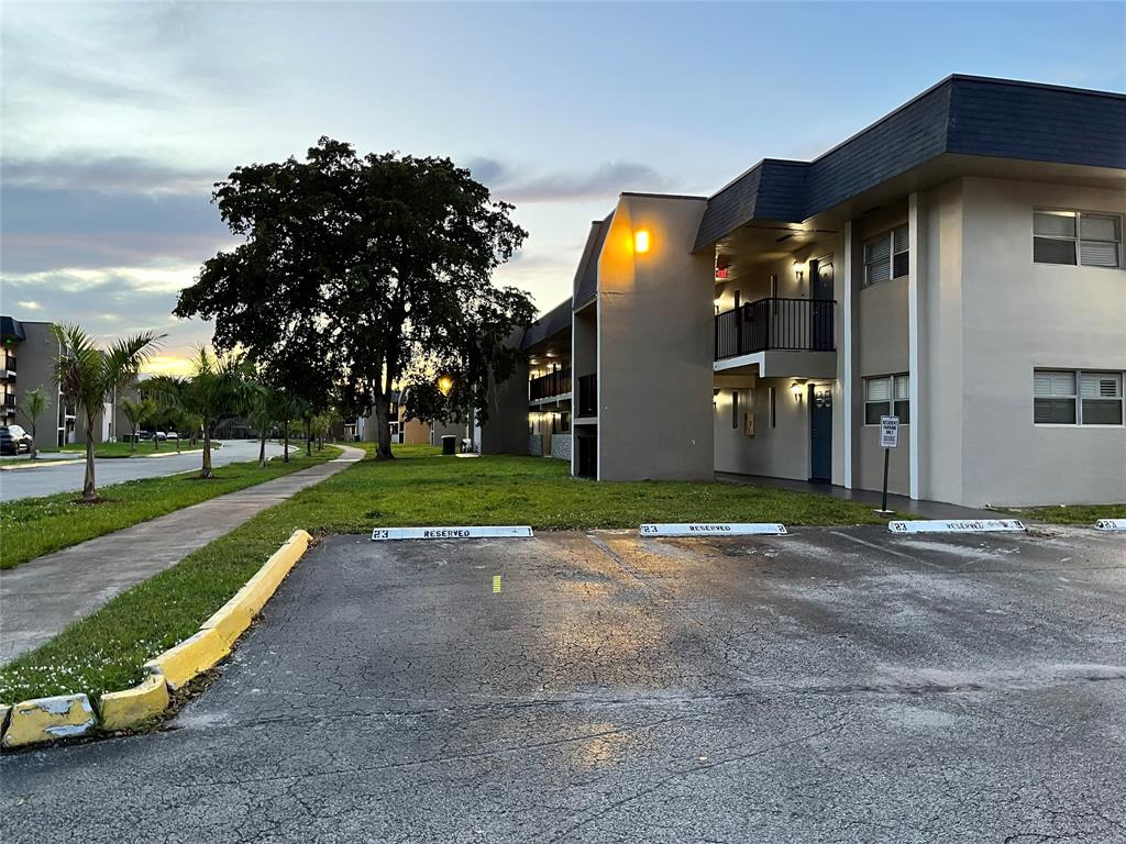 7925 Fairview Drive, Unit 101 Tamarac, FL 33321 - Photo 2 of 48 a view of a house with entertaining space and a yard